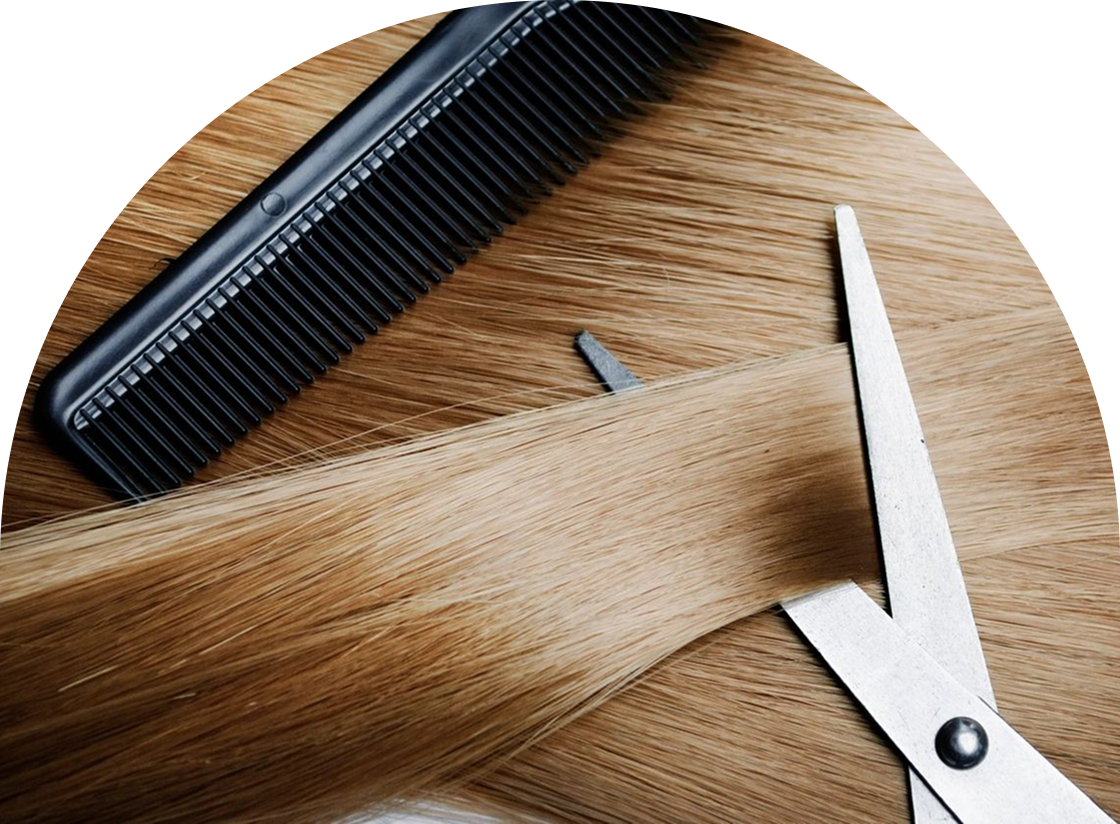 A black comb and silver scissors rest on long, straight strands of light brown hair, evoking the precision of waxing and hair removal.